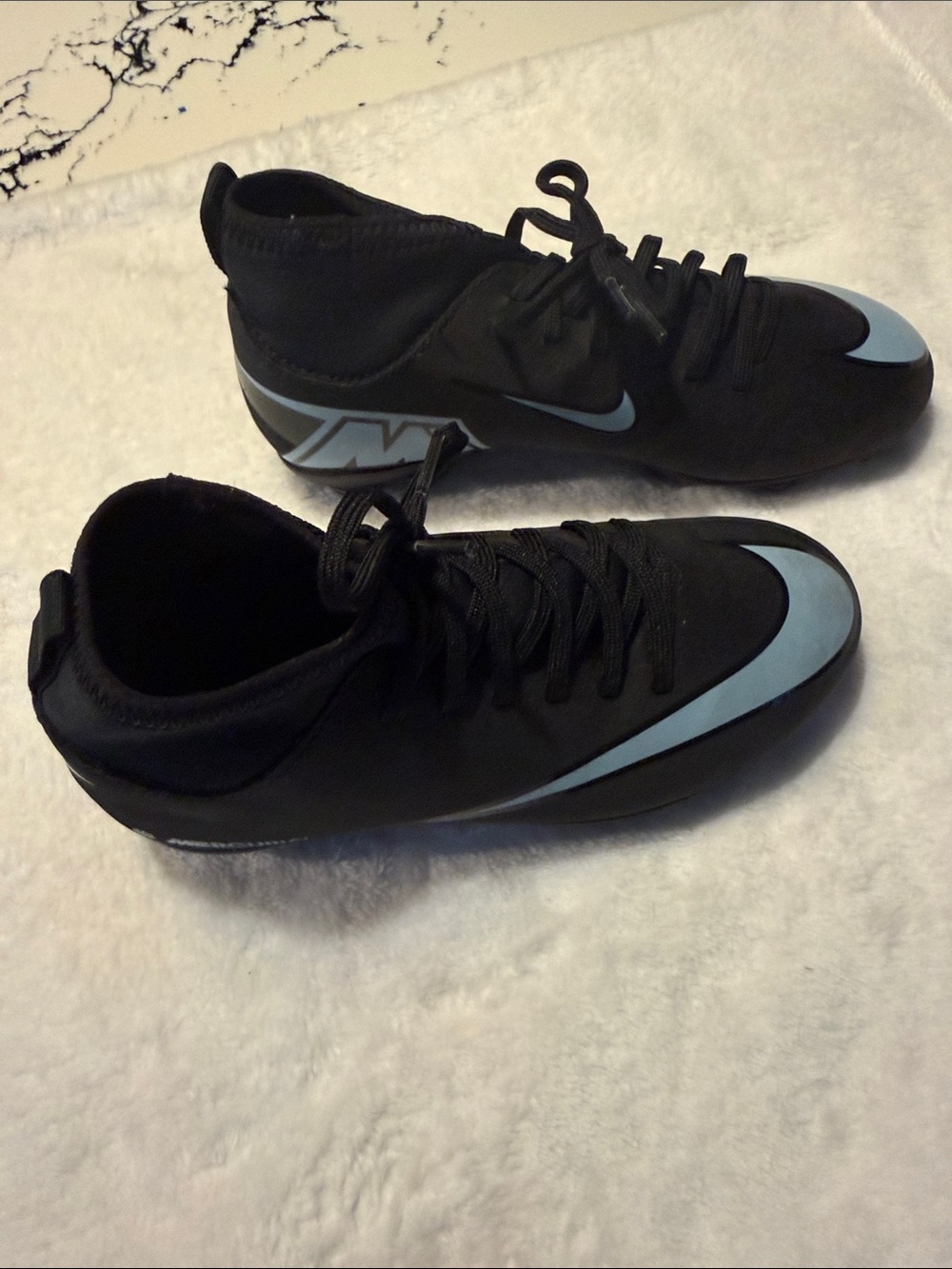 Nike Kids Black Cleats with Light Blue Swoosh